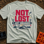 Unmanaged On Purpose - T-Shirt in Bay - Large text reading "NOT LOST JUST UNMANAGED" alongside icons of a compass, low...