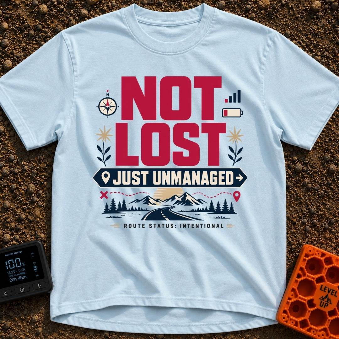 Unmanaged On Purpose - T-Shirt in Chambray - Large text reading "NOT LOST JUST UNMANAGED" alongside icons of a compass,...