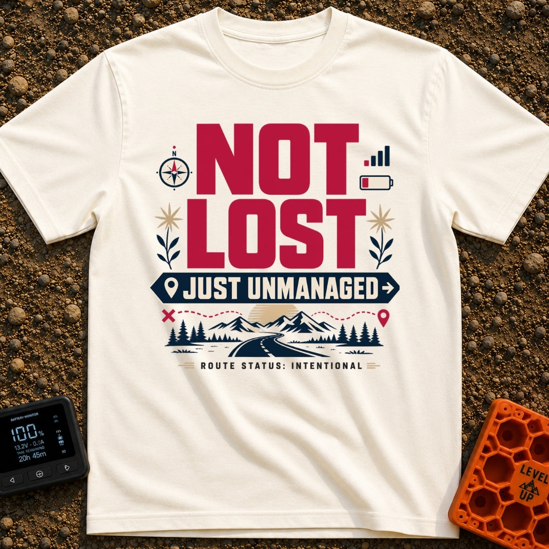 Unmanaged On Purpose - T-Shirt in Ivory - Large text reading "NOT LOST JUST UNMANAGED" alongside icons of a compass, low...