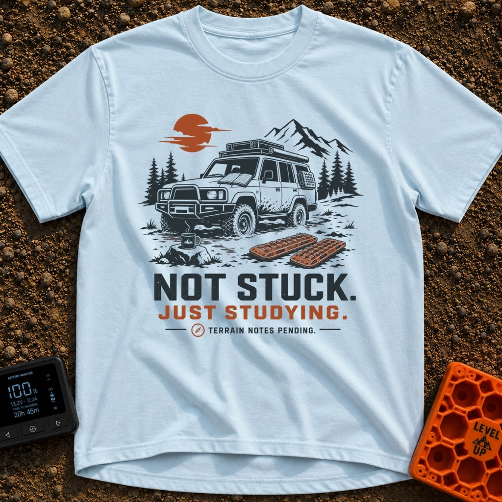 Not Stuck Just Studying - T-Shirt in Chambray - An illustration of a muddy 4x4 SUV stopped on a rugged trail, with an...