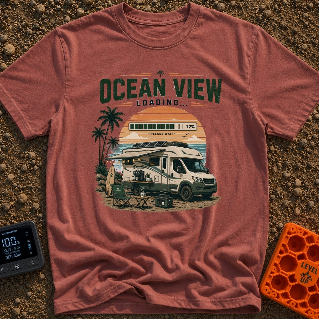 Ocean View Loading - T-Shirt in Brick - An RV parked by the beach at sunset with its awning extended, featuring...
