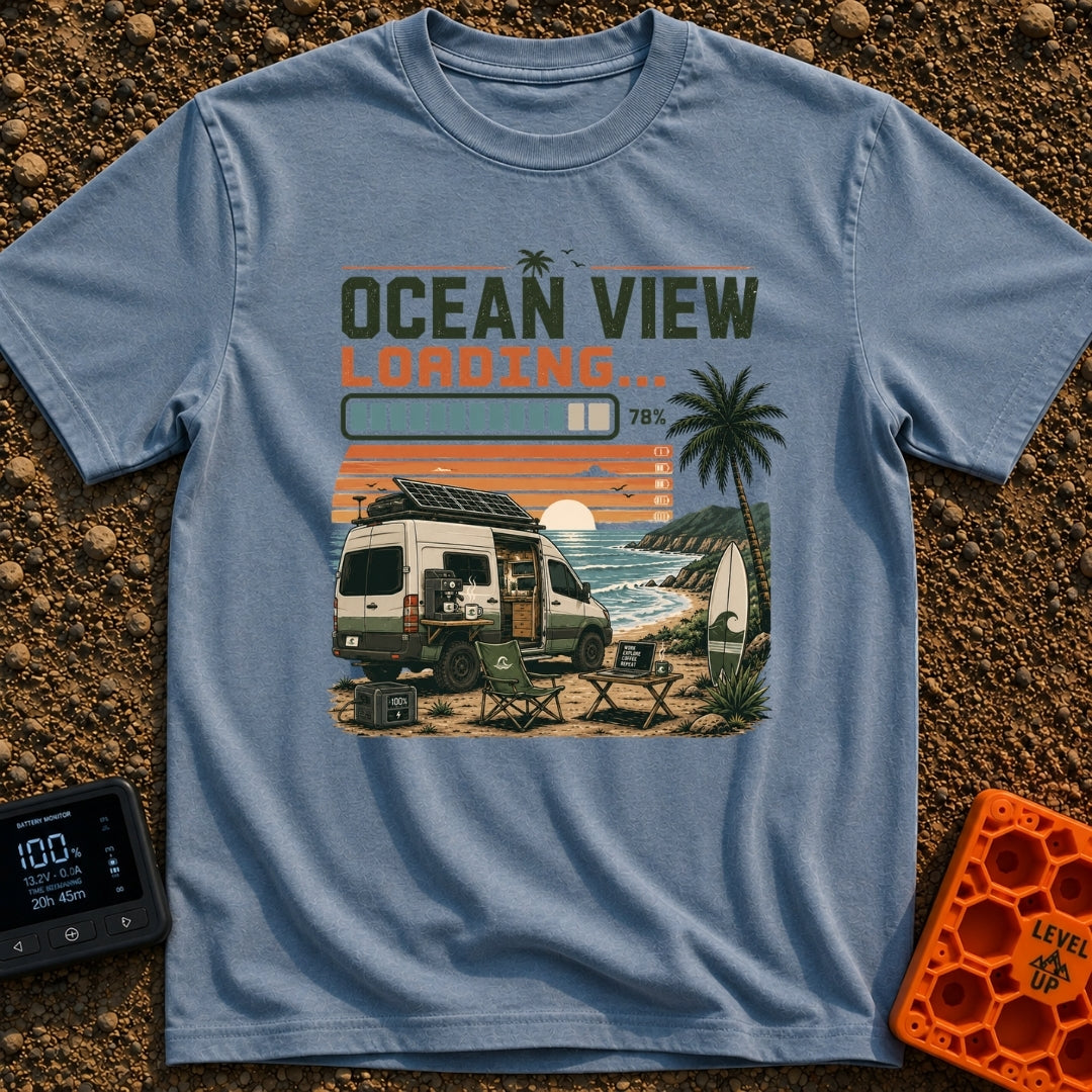 Ocean View Loading - T-Shirt in Blue Jean - A camper van is parked by the ocean at sunset with a roof-mounted solar panel...