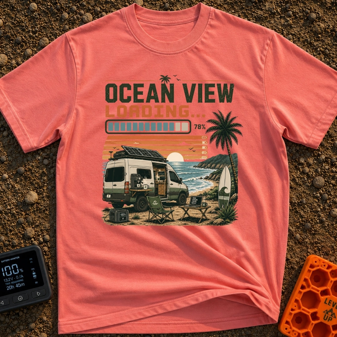Ocean View Loading - T-Shirt in Watermelon - A camper van is parked by the ocean at sunset with a roof-mounted solar...