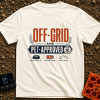 Paws And Power - T-Shirt in Ivory - Typographic design reading "OFF-GRID AND PET-APPROVED" alongside a paw print stamp,...