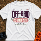 Off Grid But Cute - T-Shirt in White - A typographic design reading "OFF-GRID BUT STILL CUTE ABOUT IT" featuring small...