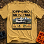 Off Grid On Purpose - T-Shirt in Mustard - The artwork shows a white camper van parked in a mountainous landscape,...
