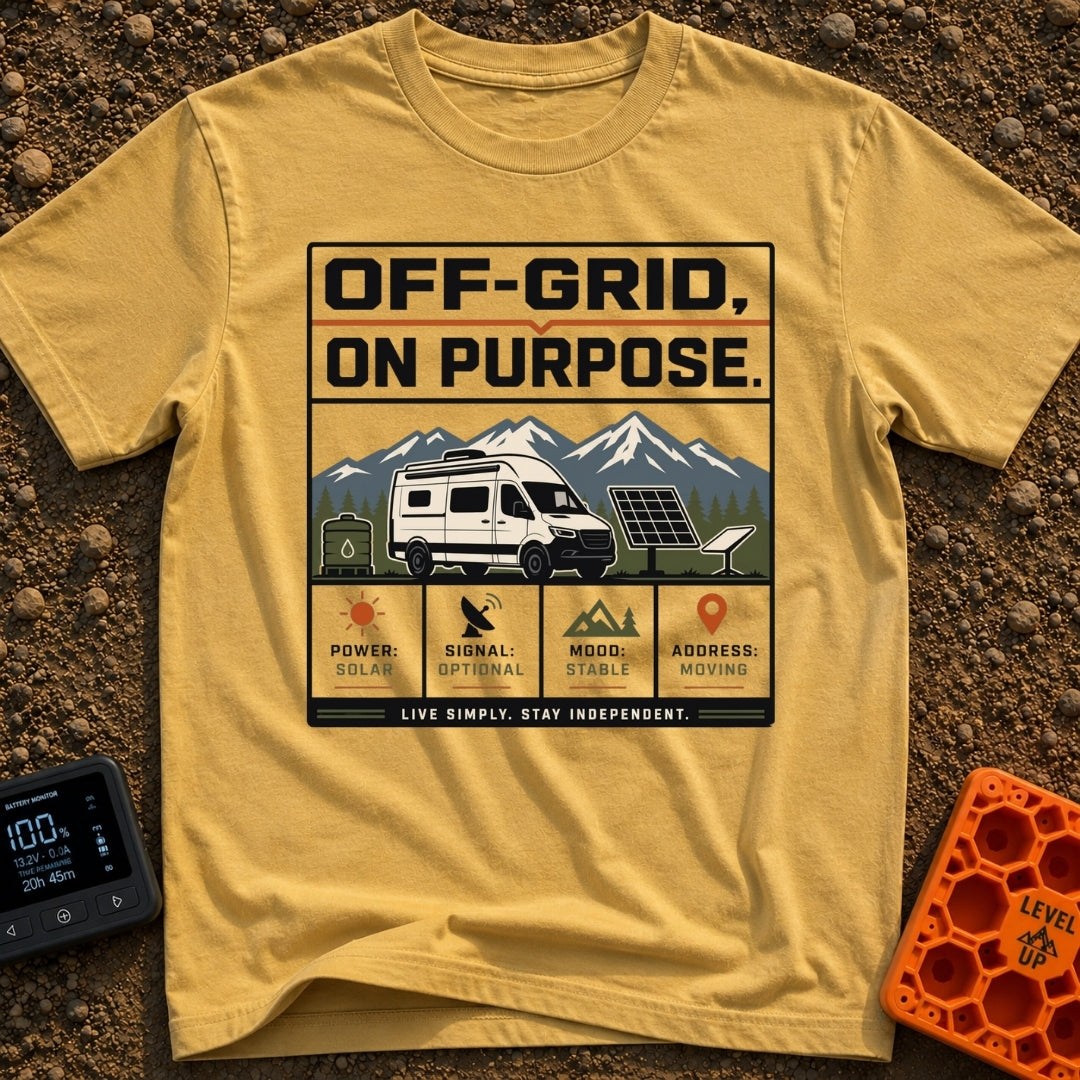 Off Grid On Purpose - T-Shirt in Mustard - The artwork shows a white camper van parked in a mountainous landscape,...