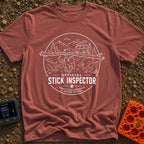 Stick It To’em - T-Shirt in Brick - A line-art illustration of a large dog carrying a massive branch in its mouth in the...