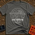 Stick It To’em - T-Shirt in Pepper - A line-art illustration of a large dog carrying a massive branch in its mouth in the...