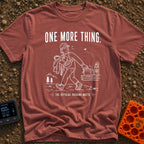Just One More Mile - T-Shirt in Brick - A white line drawing on a black background showing a hiker with their arms full...