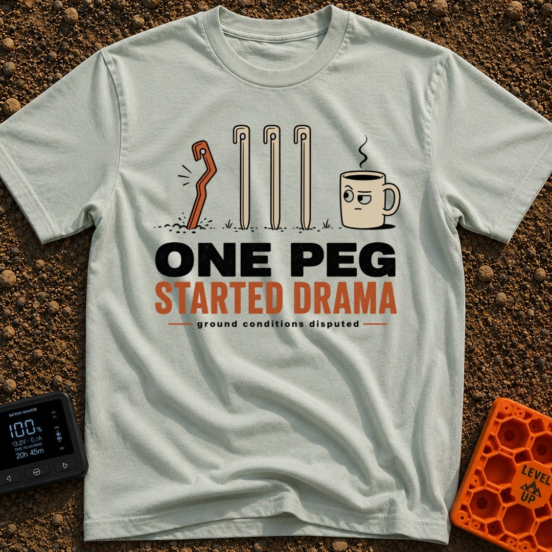 One Peg Started Drama - T-Shirt in Bay - A cartoon illustration showing four tent pegs driven into the ground, with the...