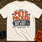 Our Pets Overpacked - T-Shirt in Ivory - A typographic design featuring the text "OUR PETS PACKED MORE THAN WE DID!" with...