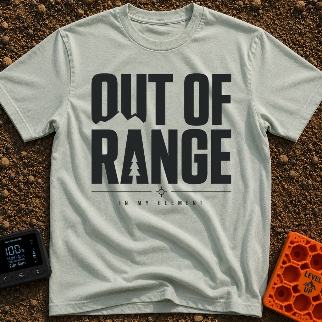 Happily Out Of Range - T-Shirt in Bay - Typographic design featuring large, bold text reading "OUT OF RANGE" with a pine...
