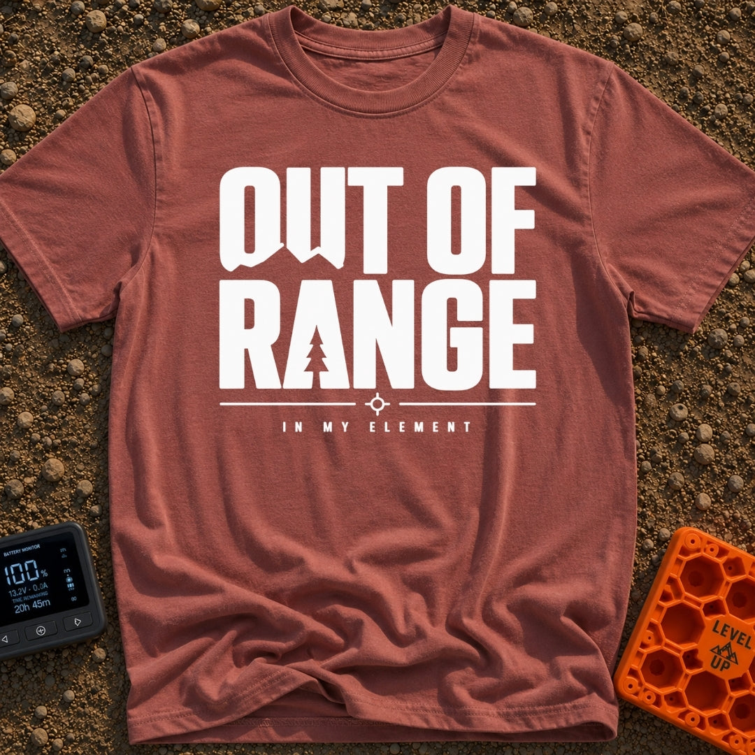 Happily Out Of Range - T-Shirt in Brick - Typographic design featuring large, bold text reading "OUT OF RANGE" with a...