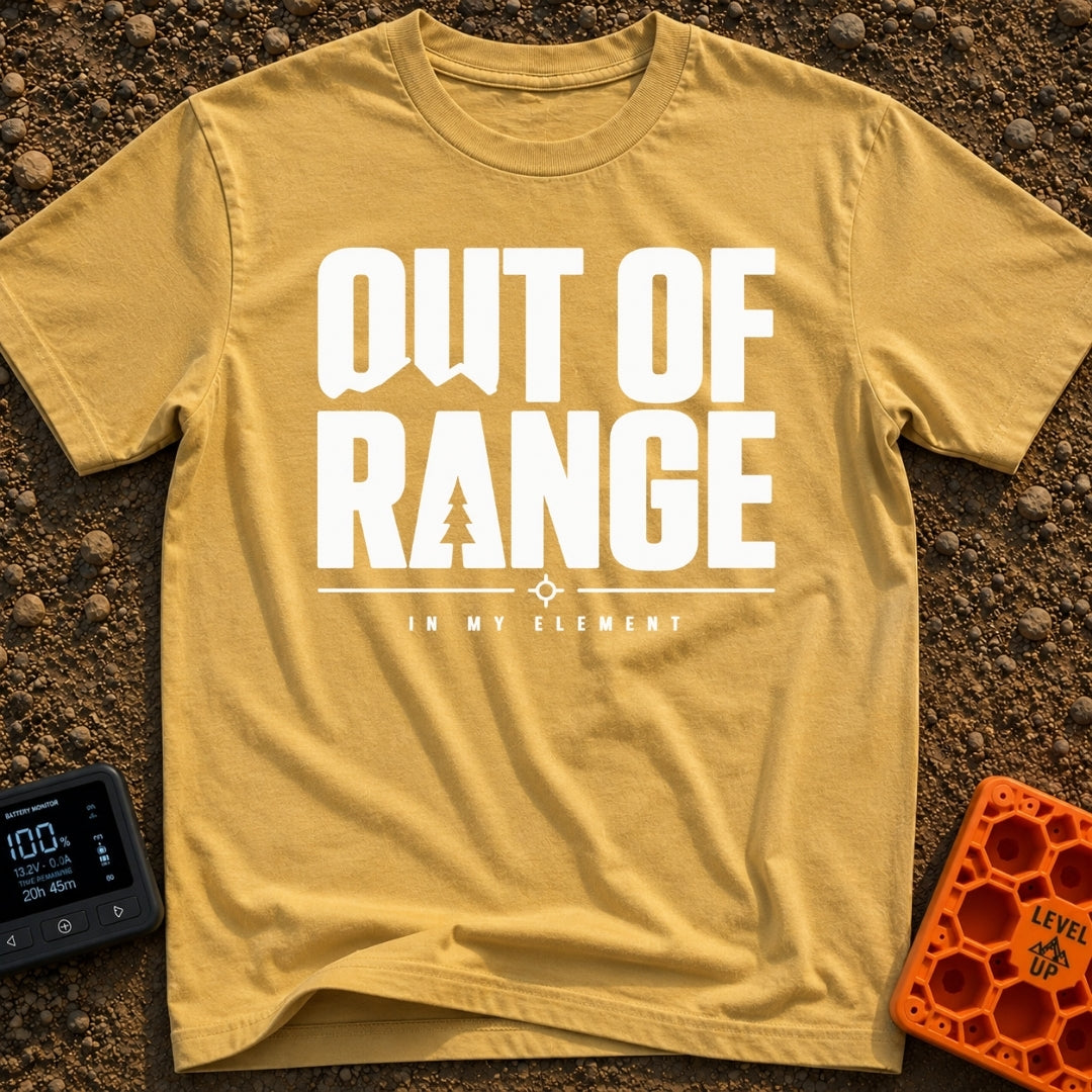 Happily Out Of Range - T-Shirt in Mustard - Typographic design featuring large, bold text reading "OUT OF RANGE" with a...