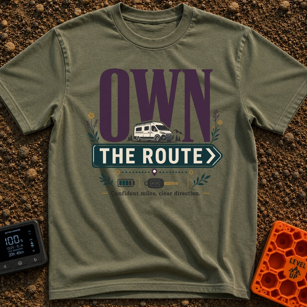 Own The Route - T-Shirt in Moss - The design features the large text "OWN" behind a white camper van, with the words "THE...