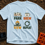 Brew View Repeat - T-Shirt in Chambray - A four-part graphic design featuring a Class C motorhome above the word 'PARK',...