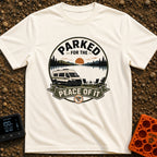Parked For Some Peace - T-Shirt in Ivory - An illustration of a camper van parked next to a calm lake with mountains and...