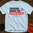 Brakes On Responsibilities Off - T-Shirt in Chambray - A typographic design stating "PARKING BRAKE ON." next to a (P)...