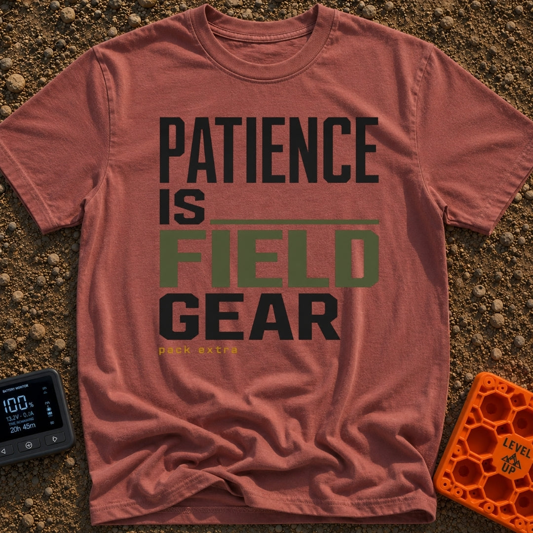 Patience Is Field Gear - T-Shirt in Brick - A typographic design featuring the stacked text "PATIENCE IS FIELD GEAR" in...