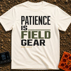 Patience Is Field Gear - T-Shirt in Ivory - A typographic design featuring the stacked text "PATIENCE IS FIELD GEAR" in...