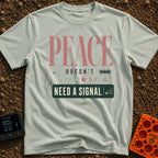Peace Needs No Signal - T-Shirt in Bay - A typographic design reading "PEACE DOESN'T NEED A SIGNAL" accompanied by icons...