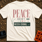 Peace Needs No Signal - T-Shirt in Ivory - A typographic design reading "PEACE DOESN'T NEED A SIGNAL" accompanied by...