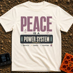 Peace Power System - T-Shirt in Ivory - A typographic design featuring the large text "PEACE IS A POWER SYSTEM", where...