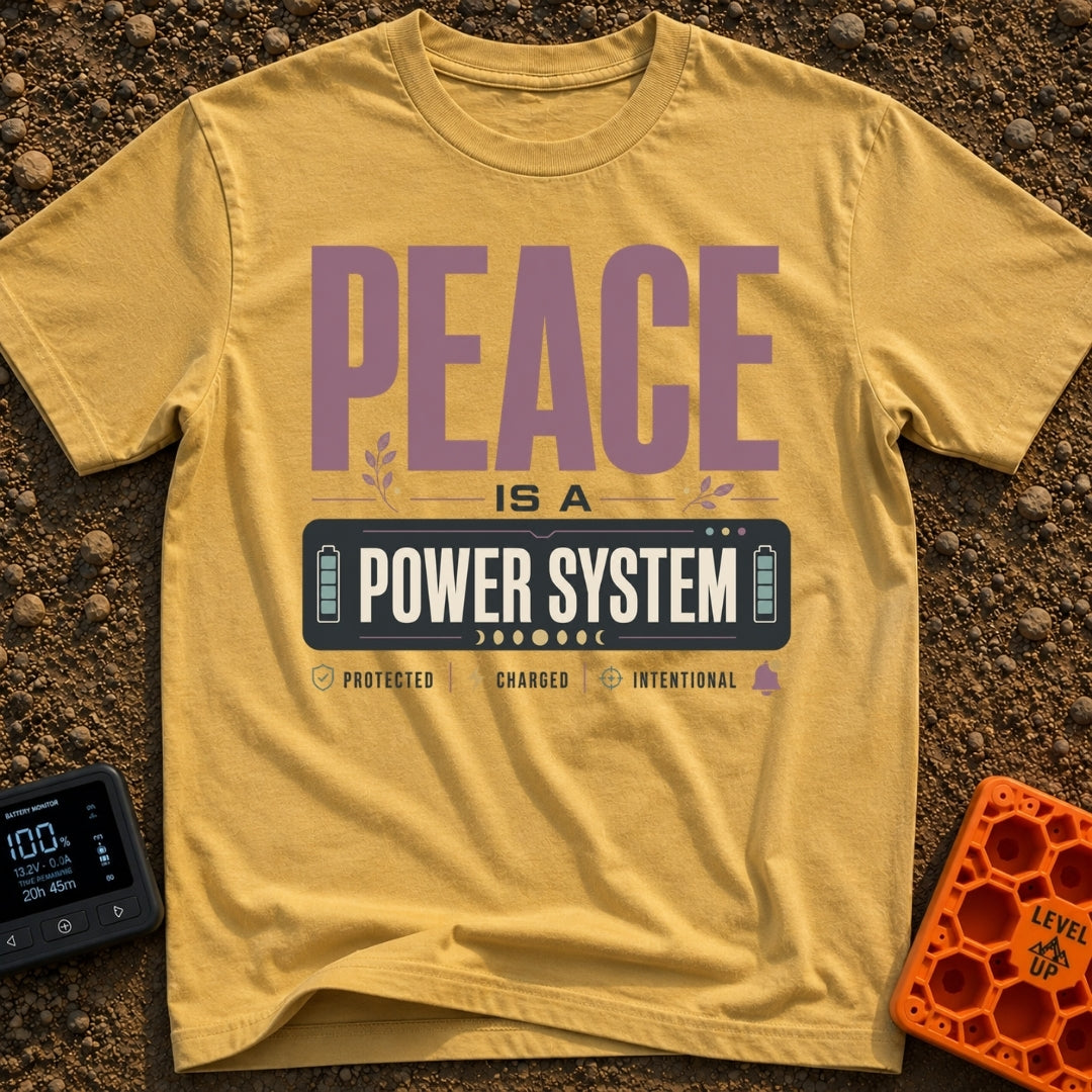 Peace Power System - T-Shirt in Mustard - A typographic design featuring the large text "PEACE IS A POWER SYSTEM", where...