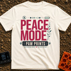 Paws And Quiet - T-Shirt in Ivory - A typographic design featuring the words "PEACE MODE" in large red letters above a...