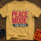 Paws And Quiet - T-Shirt in Mustard - A typographic design featuring the words "PEACE MODE" in large red letters above a...