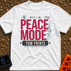 Paws And Quiet - T-Shirt in White - A typographic design featuring the words "PEACE MODE" in large red letters above a...