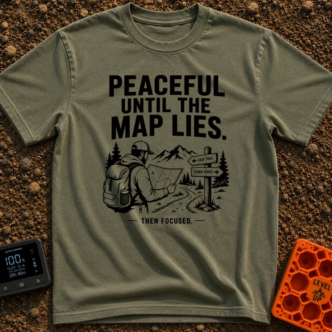 Peaceful Until Maps Lie - T-Shirt in Moss - A black and white illustration of a bearded hiker wearing a backpack and cap,...