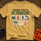 Elements Of RV Chaos - T-Shirt in Mustard - The design features the text "PERIODIC TABLE OF RV PROBLEMS" above seven...