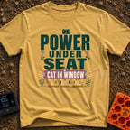 Watts And Whiskers - T-Shirt in Mustard - A typographic design reading 'POWER UNDER SEAT' and 'CAT IN WINDOW' alongside...