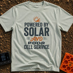 No Bars All Solar - T-Shirt in Bay - A typographic design featuring the text "POWERED BY SOLAR AND POOR CELL SERVICE" in...
