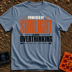 Solar Powered Overthinking - T-Shirt in Blue Jean - A typography-based design featuring the text "POWERED BY SUNLIGHT AND...