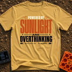 Solar Powered Overthinking - T-Shirt in Mustard - A typography-based design featuring the text "POWERED BY SUNLIGHT AND...