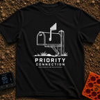 Priority Mail Connection - T-Shirt in Black - A black and white illustration of a classic roadside mailbox on a wooden...