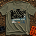 Peak Raccoon Energy - T-Shirt in Moss - A graphic illustration featuring the text 'Raccoon Energy Campground Edition'...