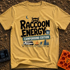 Peak Raccoon Energy - T-Shirt in Mustard - A graphic illustration featuring the text 'Raccoon Energy Campground Edition'...