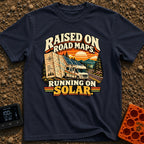 Raised On Roadmaps - T-Shirt in Navy - A retro-style motorhome with a large solar panel on its roof drives along a...