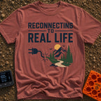 Logging Into Life - T-Shirt in Brick - The design displays the text "RECONNECTING TO REAL LIFE" above an illustration of...
