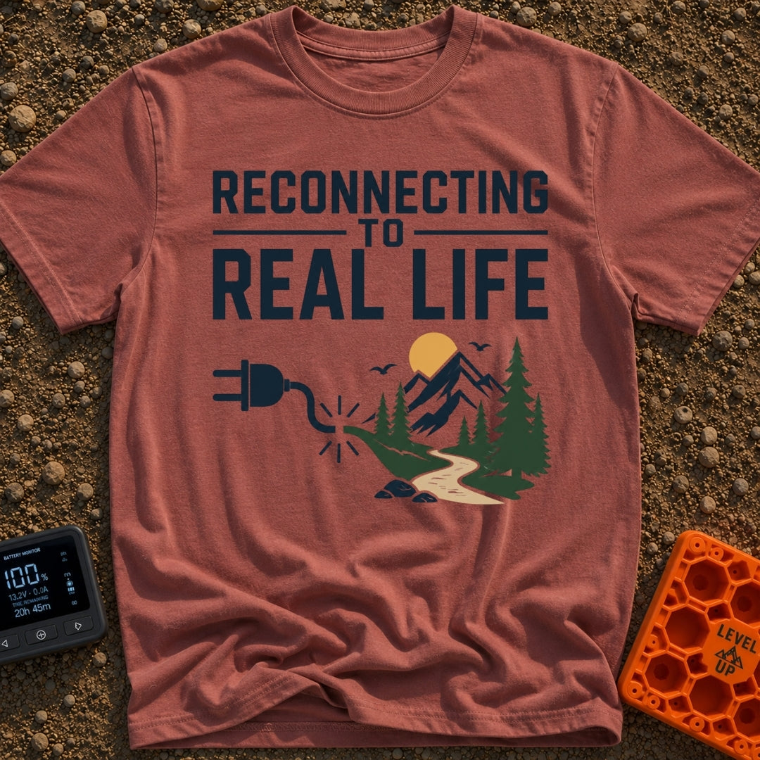Logging Into Life - T-Shirt in Brick - The design displays the text "RECONNECTING TO REAL LIFE" above an illustration of...