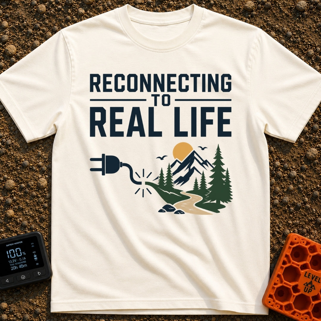 Logging Into Life - T-Shirt in Ivory - The design displays the text "RECONNECTING TO REAL LIFE" above an illustration of...