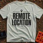 Working From Nowhere - T-Shirt in Bay - Text reading 'REMOTE LOCATION' in large black letters with the 'A' stylized as a...