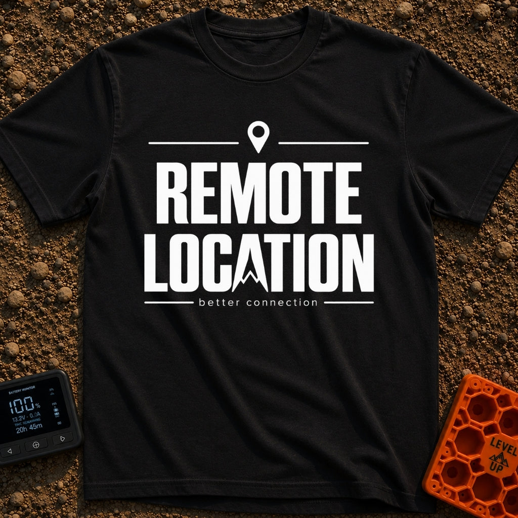 Working From Nowhere - T-Shirt in Black - Text reading 'REMOTE LOCATION' in large black letters with the 'A' stylized as...