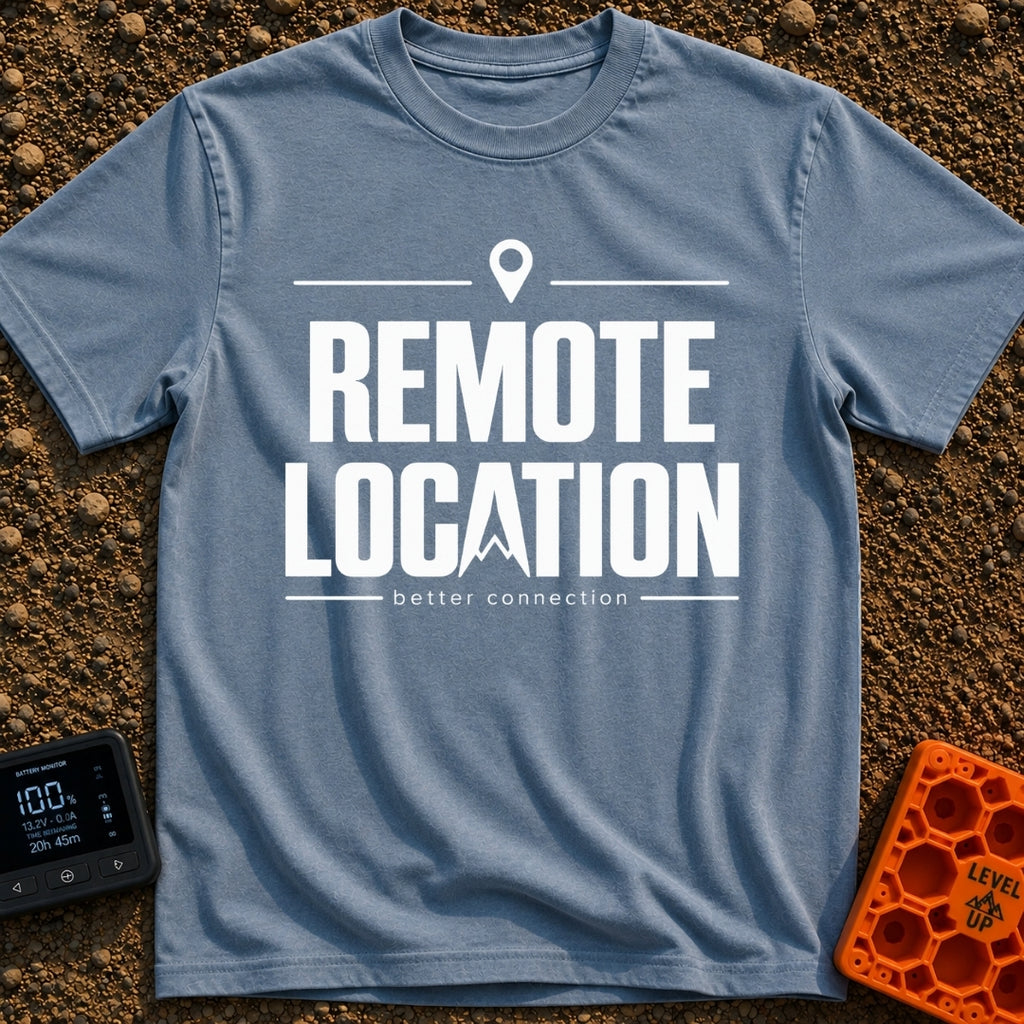 Working From Nowhere - T-Shirt in Blue Jean - Text reading 'REMOTE LOCATION' in large black letters with the 'A' stylized...