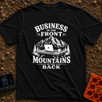 Working From Roam - T-Shirt in Black - A black and white illustration of an open laptop and a mug sitting on a wooden...