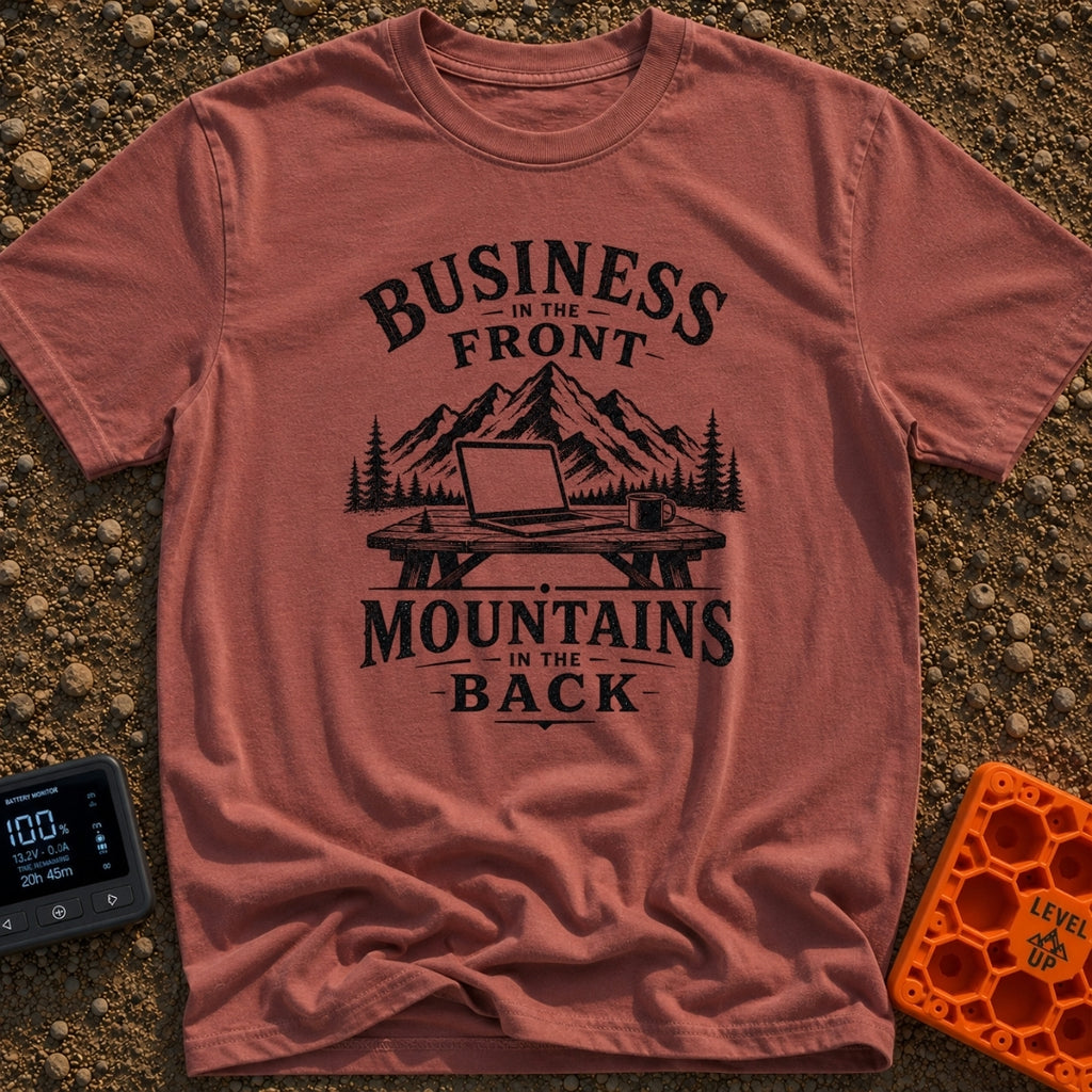Working From Roam - T-Shirt in Brick - A black and white illustration of an open laptop and a mug sitting on a wooden...